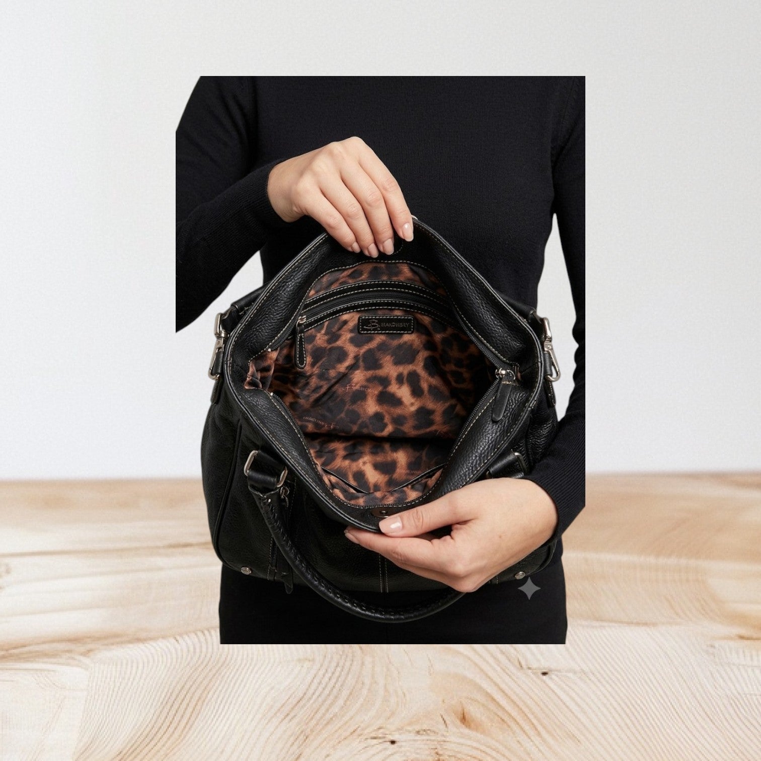 Marcia's Chic Boutique black faux leather hobo bag with embossed crocodile texture and leopard print lining.